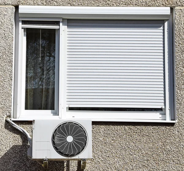 Air conditioner next to a window — Stock Photo, Image