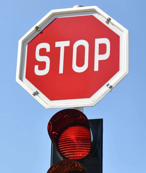Stop sign and red light at the road crossing — Stock Photo, Image