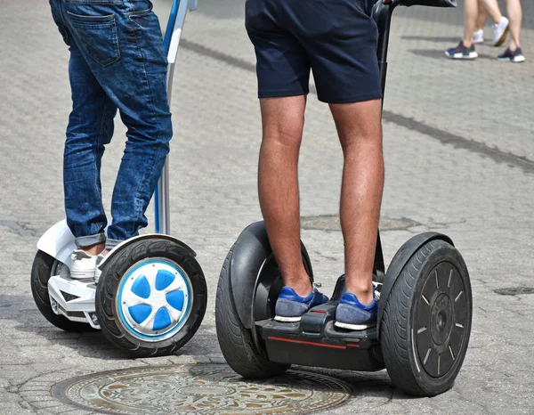 Men on electric rollers on the street — Stock Photo, Image