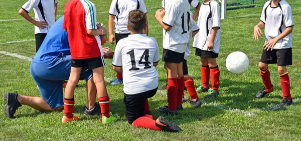 Kid soccer team discussion with the coach