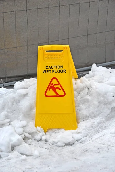 Caution wet floor sign outdoor in winter