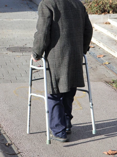 Old man walks on the street with a walker — Stock Photo, Image