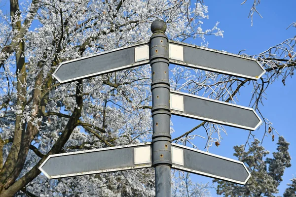 Metal sign pole in winter time
