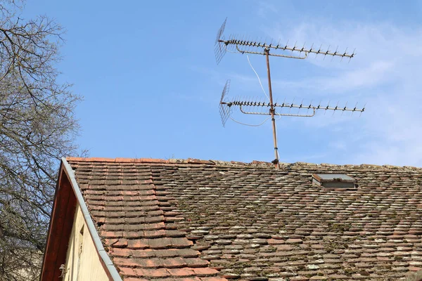 Television antenna on the roof of an old house
