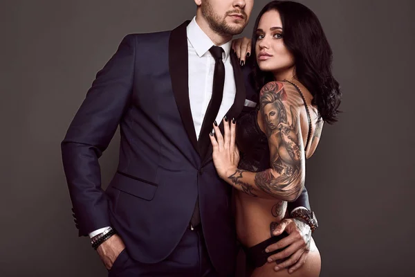 Portrait of a brutal man in suit and sexy girl — Stock Photo, Image