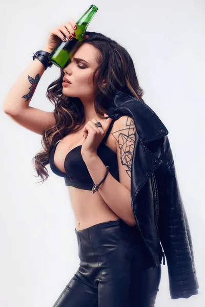 Young sexy girl with long hair in leather jacket with beer — Stock Photo, Image