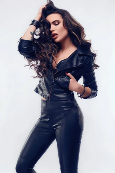 Young sexy girl with long hair in leather jacket — Stock Photo, Image