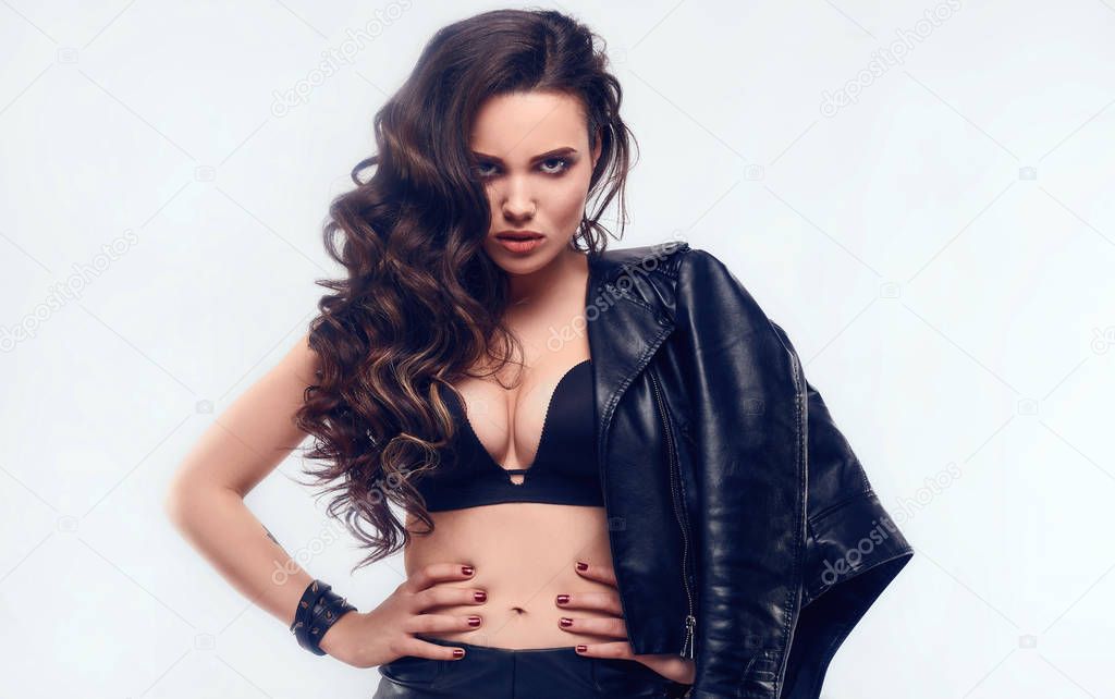 Young sexy girl with long hair in leather jacket