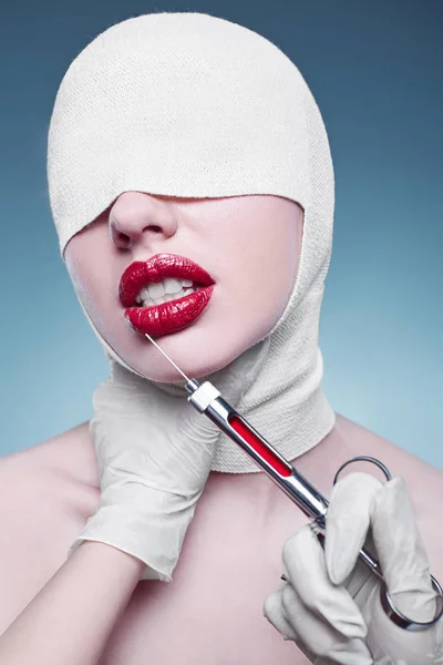 young fashion woman with bandaged head and injector
