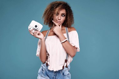 Elegant black woman model with curly hair and camera