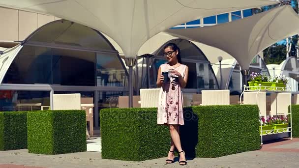 Симпатичная и шикарная женщина в модном платье на террасе ресторана — стоковое видео