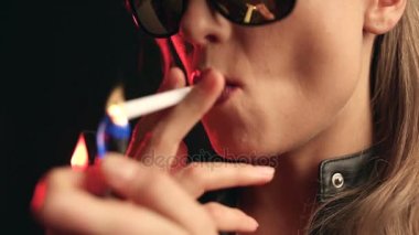 Studio siyah arka plan üzerine bir sigara gözlüklü zarif sarışın kadın portresi