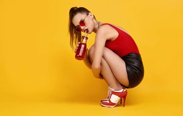 Елегантна дівчина гламурного хіпстера в червоному верхньому куті, чорні шорти з коктейльним напоєм — стокове фото