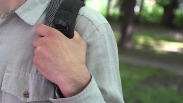 Young Caucasian Man Park Holds His Hand Strap Backpack Close — Stock Video