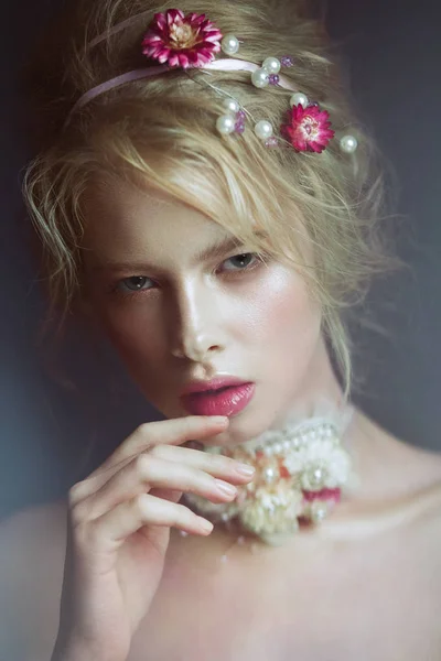 Linda menina da moda loira com flores no pescoço e em seu cabelo, maquiagem nua molhada. Cara de beleza . — Fotografia de Stock