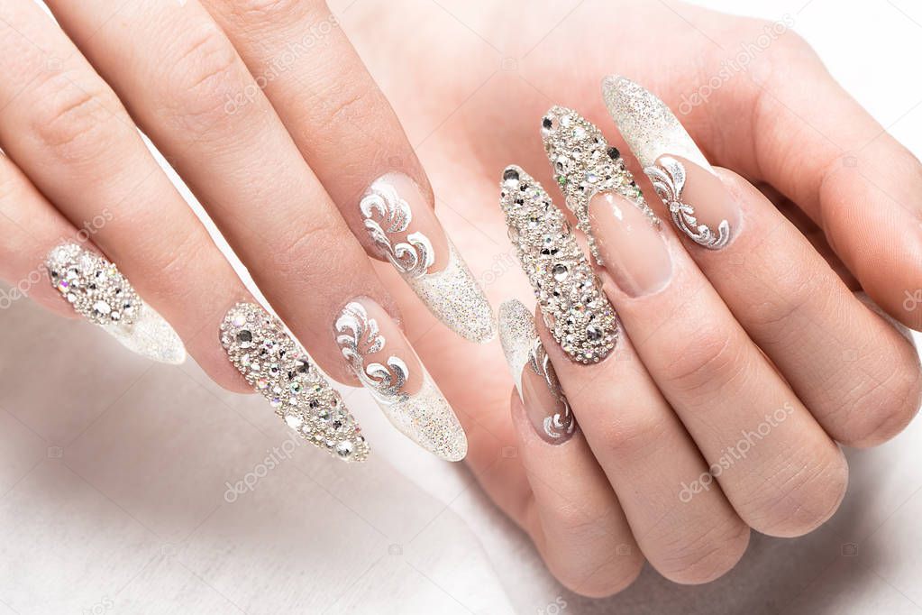 Beautifil wedding manicure for the bride in gentle tones with rhinestone. Nail Design. Close-up