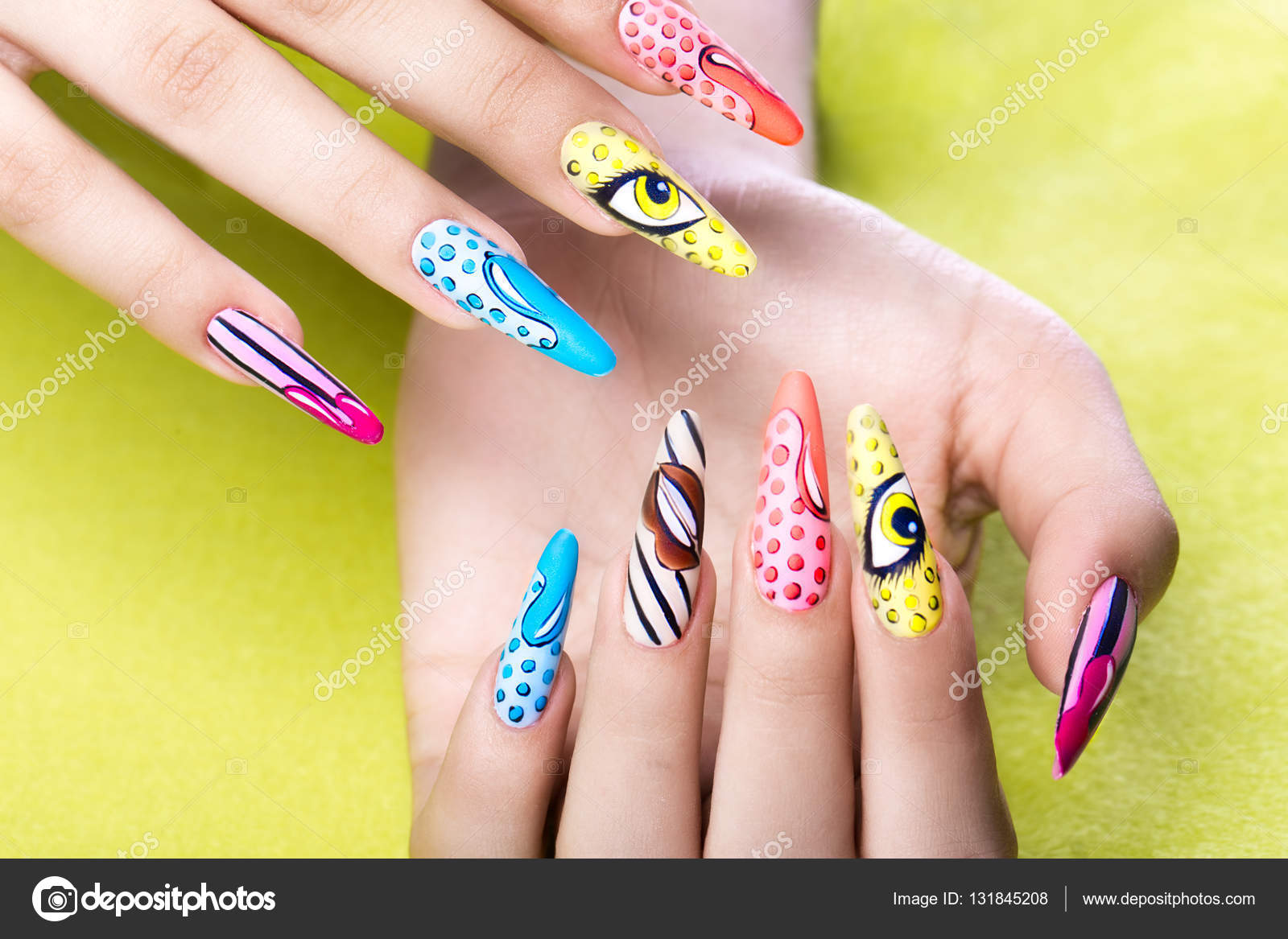 Long beautiful manicure in pop-art style on female fingers. Nails design.  Close-up Stock Photo by ©kobrin-photo 131845208