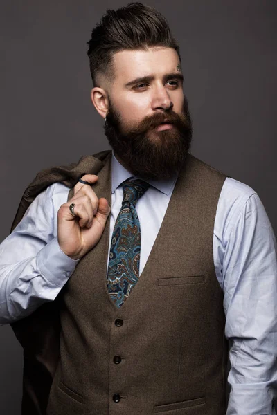 Solid man with beard and mustache in classic fashionable suit.