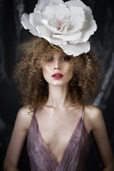 Beautiful girl with curly hair in lingerie and large flower. beauty face. — Stock Photo, Image