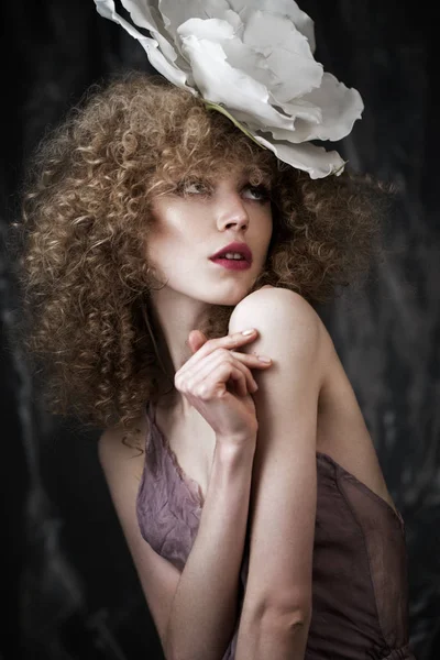 Beautiful girl with curly hair in lingerie and large flower. beauty face. — Stock Photo, Image