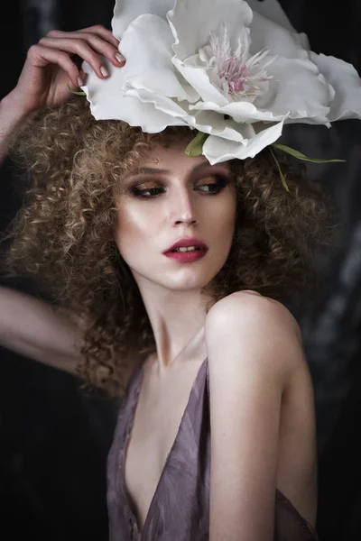 Beautiful girl with curly hair in lingerie and large flower. beauty face. — Stock Photo, Image