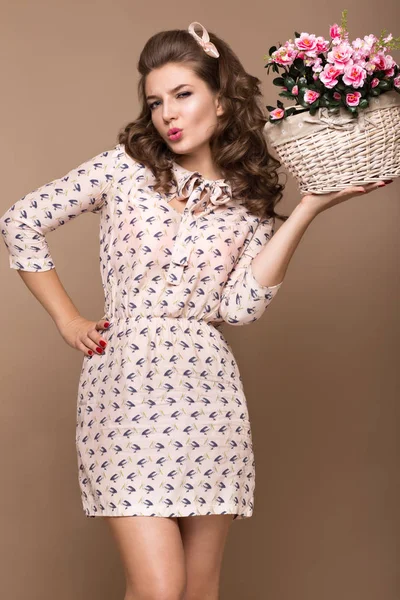 Fresh young girl, light silk dress, smile, retro curls pin-up style with basket of flowers. Beauty face , body. — Stock Photo, Image