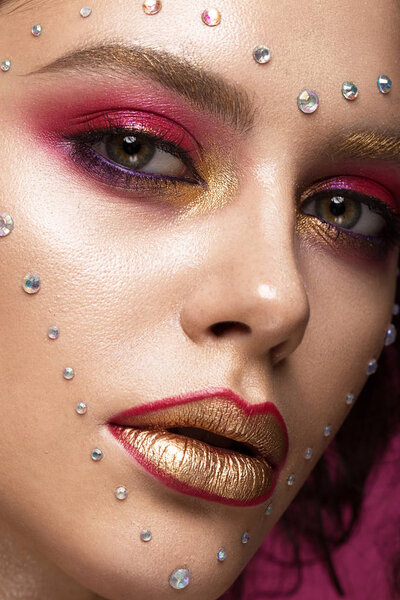 Beautiful girl with bright fashion make-up, and heart from crystals on the face. Valentines Day.