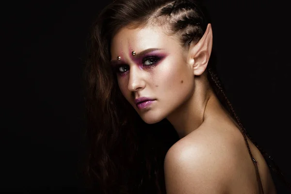 Brunette girl with a creative hairstyle braids, art make-up and the elfs ears. Beauty face. — Stock Photo, Image