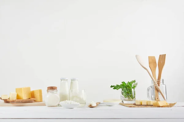 Fresh Milk, cottage cheese, sour cream, cheese, butter, eggs, On wooden table. Still life of natural products. — ストック写真