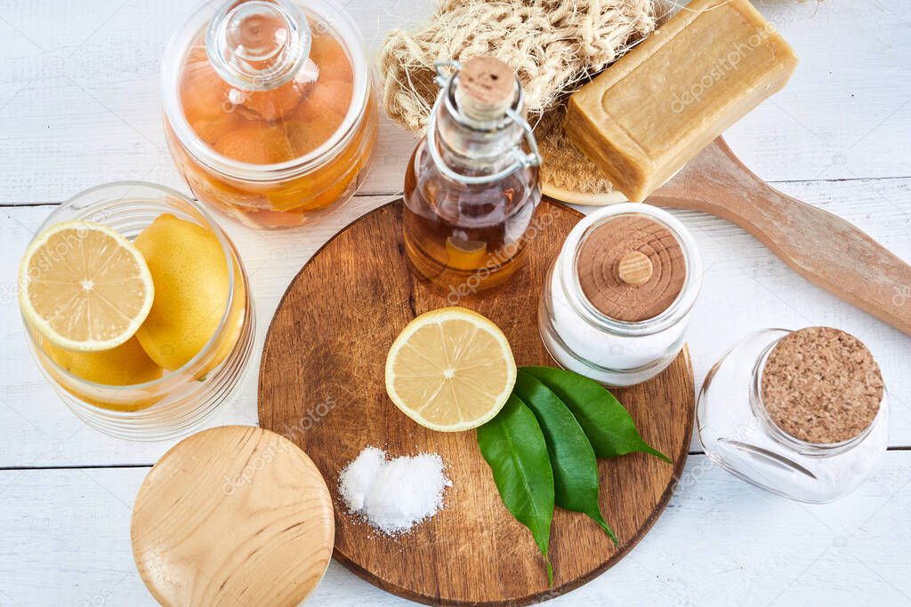 Eco-friendly natural cleaners: baking soda, soap, vinegar, salt, coffee, lemon and brush on wooden table
