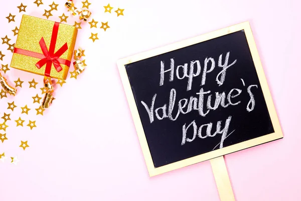 stock image Blackboard with text Happy Valentine's Day and gold star on pink background. Top view