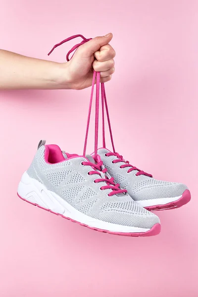 Running sports shoes on pink background, Pair of fashion stylish sneakers. Close up
