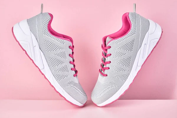 Running sports shoes on pink background, Pair of fashion stylish sneakers. Close up