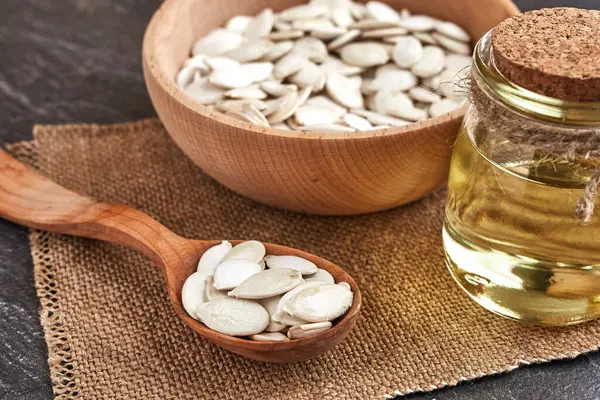 Pumpkin Seeds Wooden Spoon Dark Table Cutting Board Wooden Bowl — Stock Photo, Image