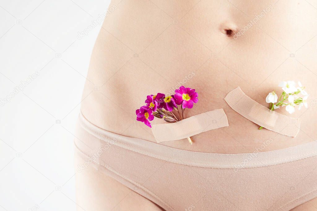 The concept of the health female reproductive system. A beautiful woman with flowers on her skin. preparation for childbirth.