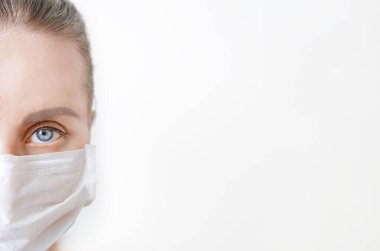Beyaz tıbbi koruyucu maskeli güzel bir kadına yakın durun. kopyalama alanı. Corona virüsü covid-19 salgınını durdurun. Grip ve bulaşıcı salgın sırasında sağlık koruma ve önleme
