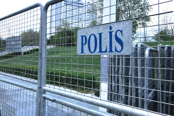 sign police in turkish language on mettalic borders barrier barricades.