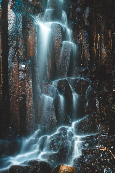 Long exposure of water running down a wall