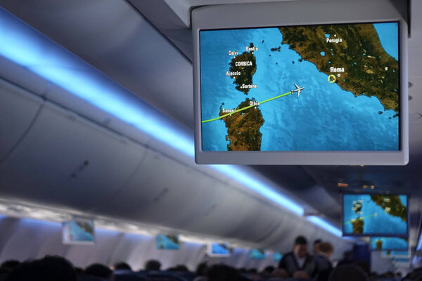 Display screen on the plane above the passenger seat, shows information about the flight, the flight from Madrid to Rome. Madrid - Rome, September 2018