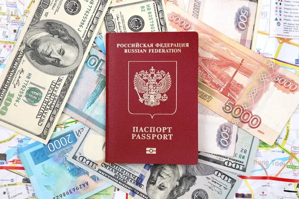 Russian passport on the background of Russian and American banknotes.
