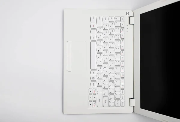 The laptop is white on a white background.