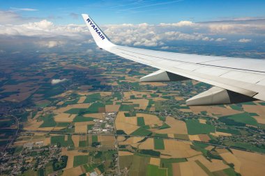 The wing of the aircraft above the clouds 