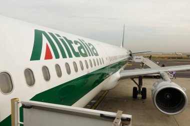 Passengers get off the plane Alitalia at the airport of Rome. Rome, Italy, April 2019.