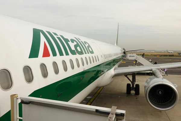 Passengers get off the plane Alitalia at the airport of Rome. Rome, Italy, April 2019.