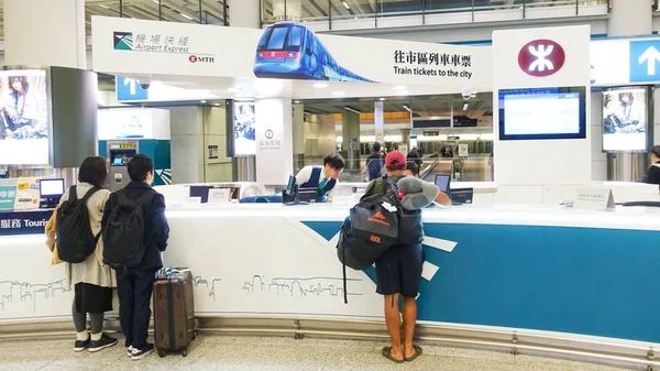 Hong Kong airport, people stand at the counter selling a ticket on the subway. Hong Kong October 2019.