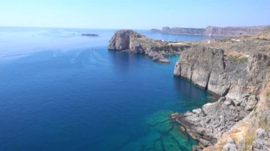 Turkuaz berrak denizi olan kayalık bir sahil. Yunanistan, Rodos Adası.