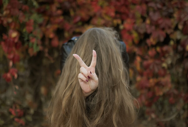 Top view photo of girl showing a sign by means  the fingers.