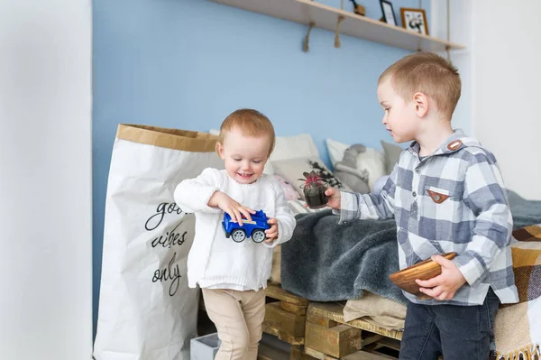 Cute boy playing with little sister at home — Stock Photo, Image