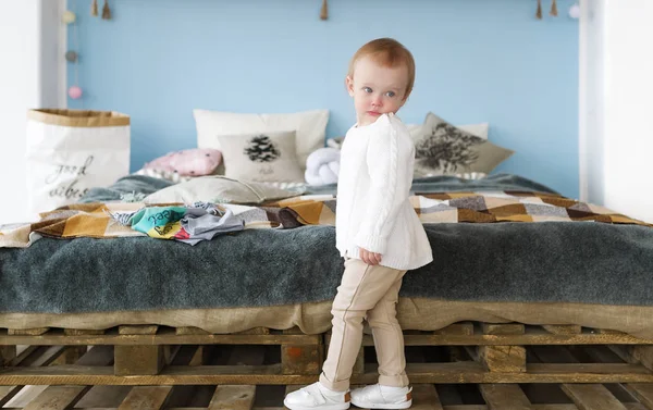 Cute little blonde girl in bedroom. Portrait of the lovely little blond girl in bedroom — Stock Photo, Image