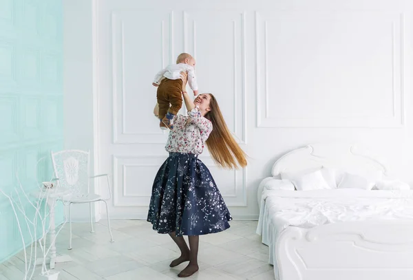 Молодая привлекательная мать играет со своим ребенком дома — стоковое фото